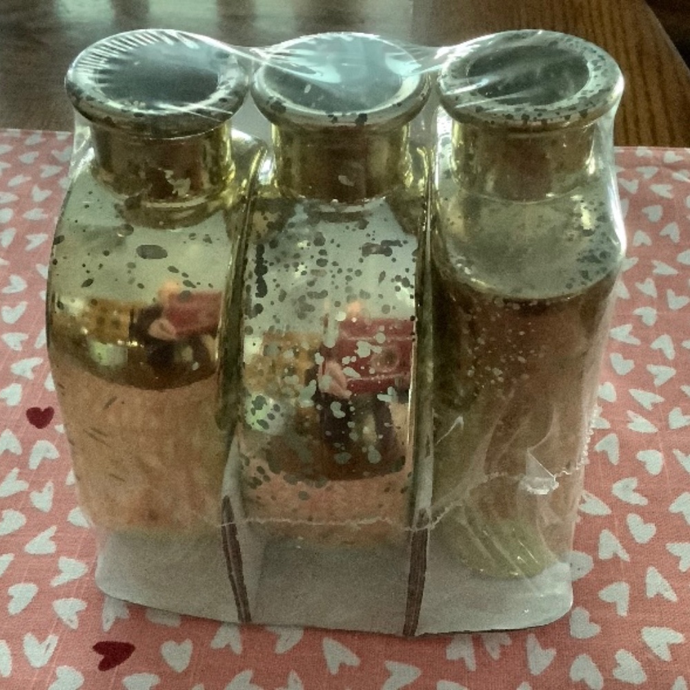 New in pack, 3 , 5 1/2 inch tall gold colored decorative bud vases